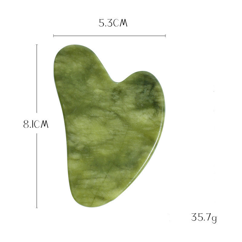 Jade gua sha stone in darker green, 8.1 cm by 5.3 cm and 35.7 g, with a notched edge for the jawline