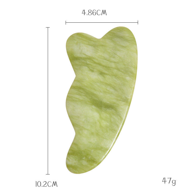 Contoured jade gua sha stone, 10.2 cm by 4.86 cm and 47 g, with a scalloped edge that tracks the jawline