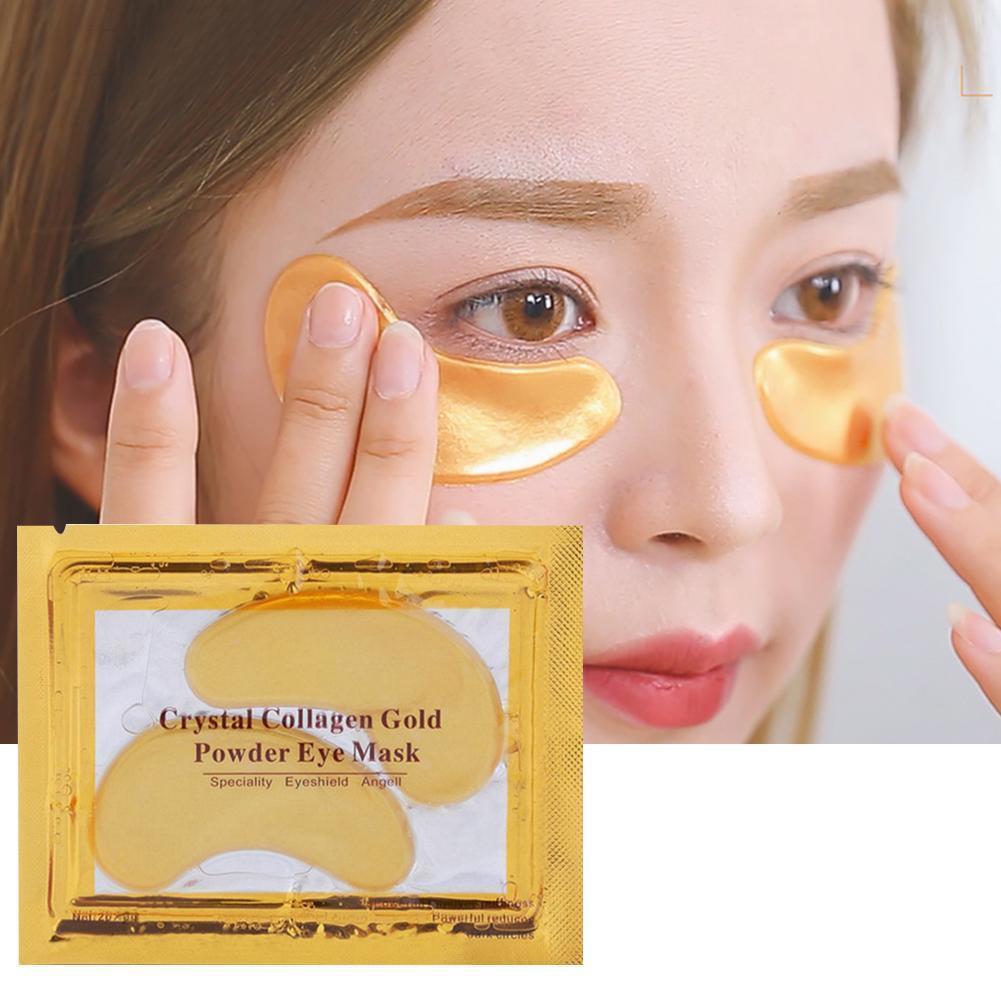 Applying a gold hydrogel eye patch under the eye, next to the sealed sachet