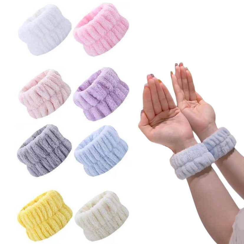 Eight colours of microfiber wrist wash bands with a light blue pair worn on the wrists to catch runoff at the sink